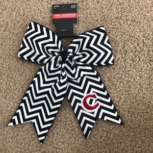 A red and black bow that has a c on it